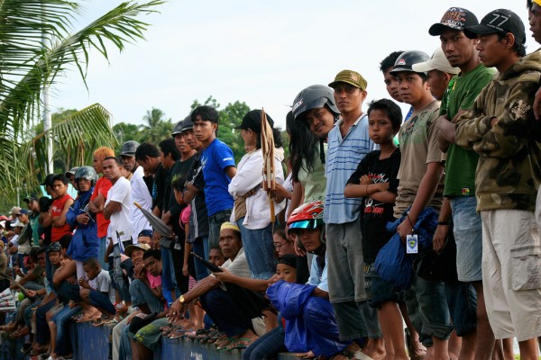 The crowd is watching the race carefully.